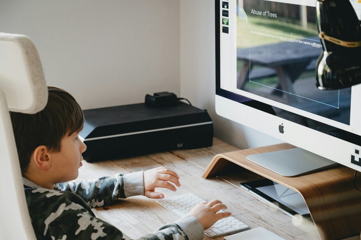 Child working on a laptop, building their learning profile